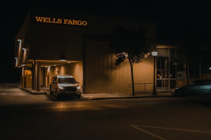 Wells Fargo bank at night with car driving through 