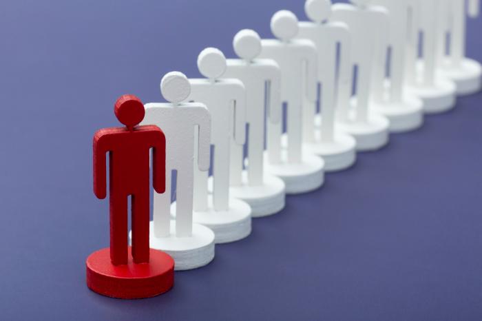 red wooden figure standing in front of a line of white wooden figures financial advisor transitions