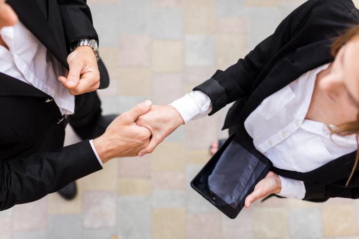 two businesspeople shake hands financial advisor transitions 
